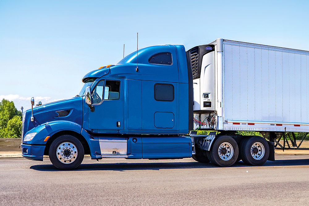 White refrigerated truck transports fresh meat on highway