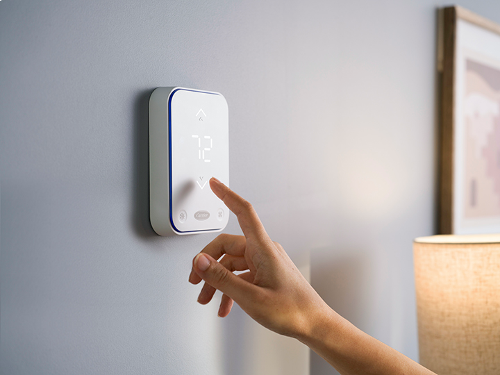 Hand using thermostat