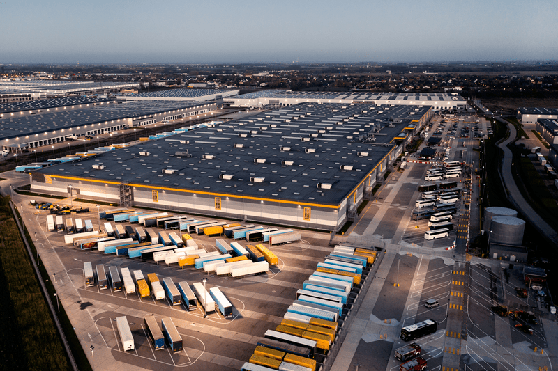 Top view of many trailers and containers near the logistics warehouse