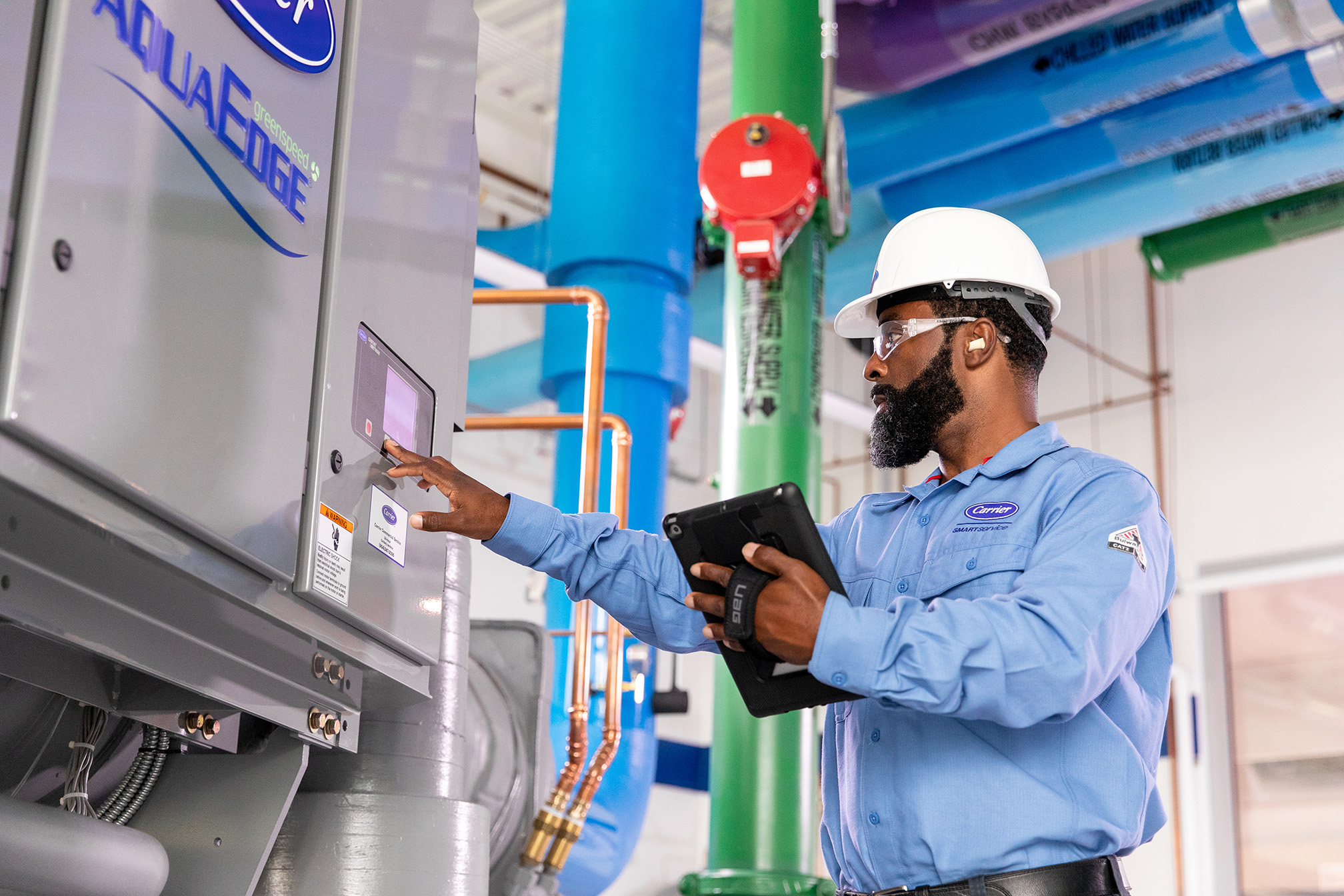 Man holding tablet servicing a system