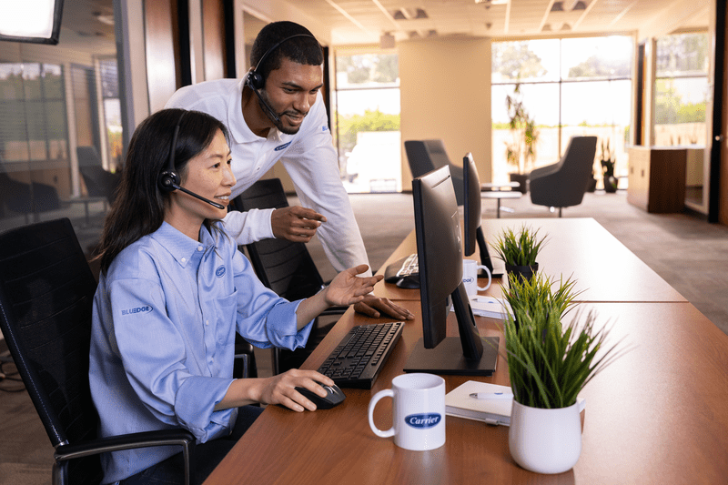 Carrier employees looking at a monitor