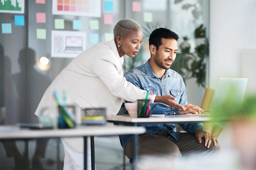 Man and woman looking at computer