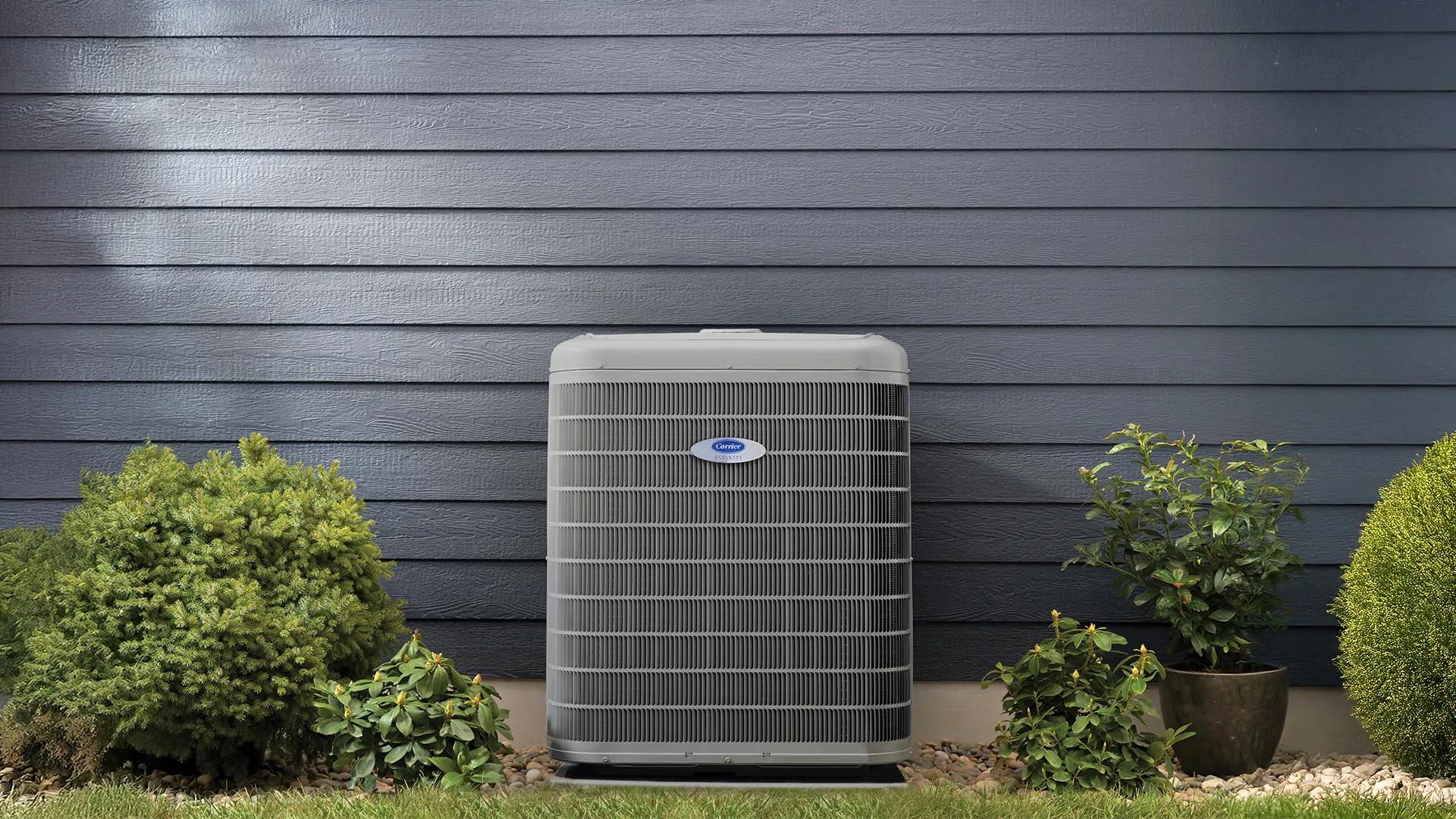 Heat pump outside with blue siding