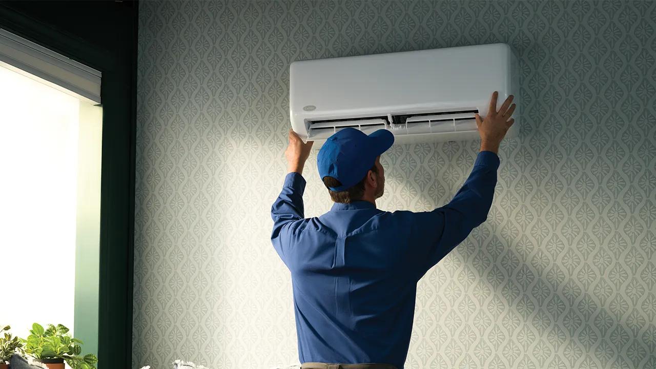 A certified ductless pro installing a highwall unit