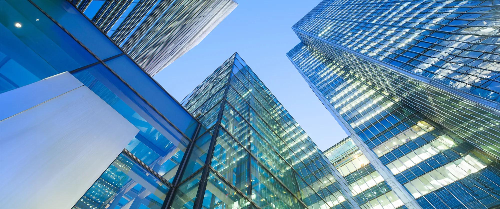 An outdoor view of a group of buildings in a city area in the evening.