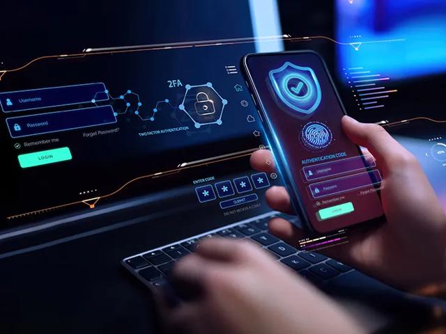 Person on mobile phone in front of computer