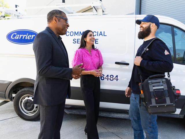 carrier service tech talking with customers outside