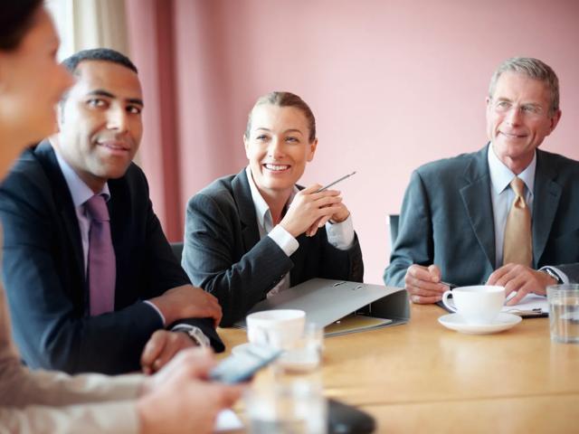 people in conference room discussing business