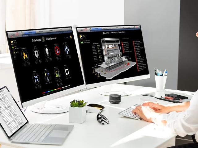 Woman at desk with WebCTRL on monitors