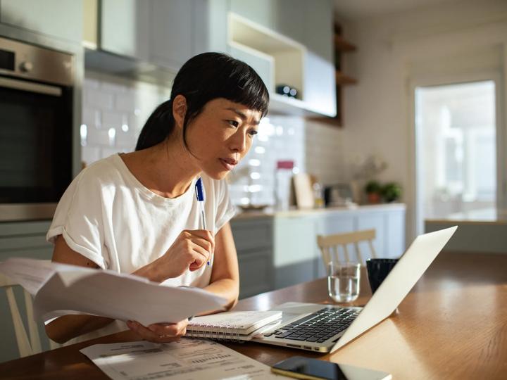 Woman on laptop reviewing warranty