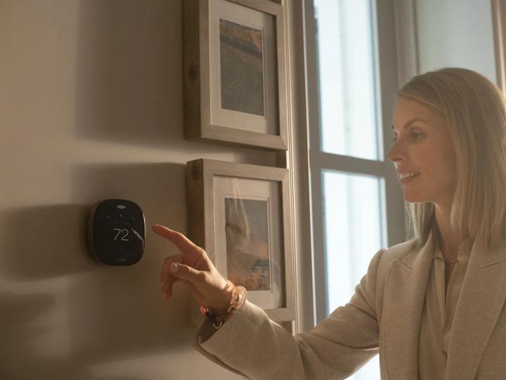 Lady using thermostat