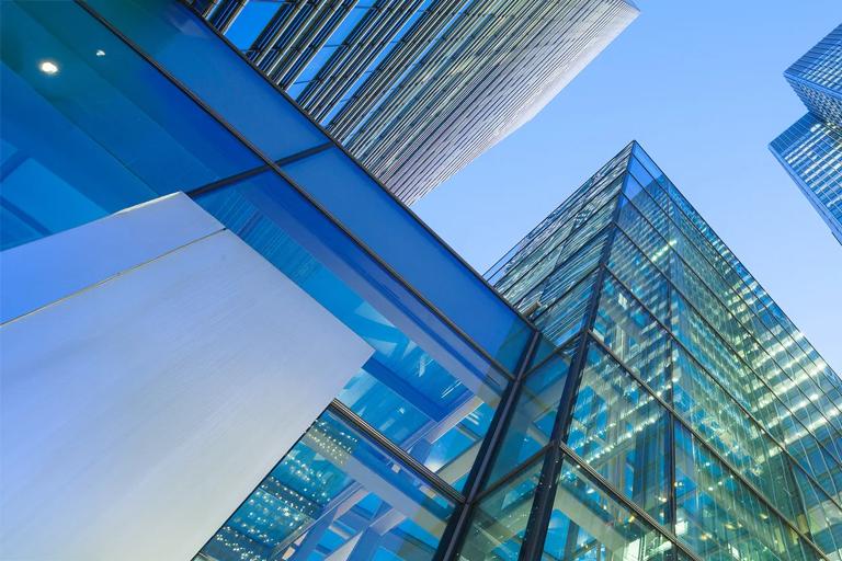 An outdoor view of a group of buildings in a city area in the evening.