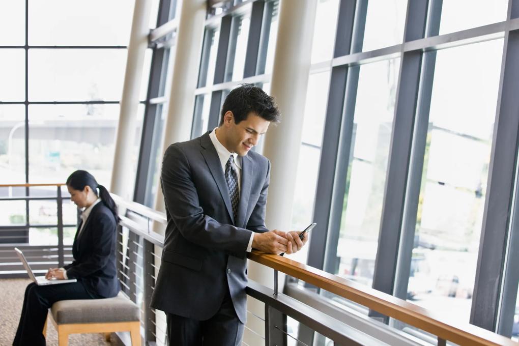man in office building on cell phone