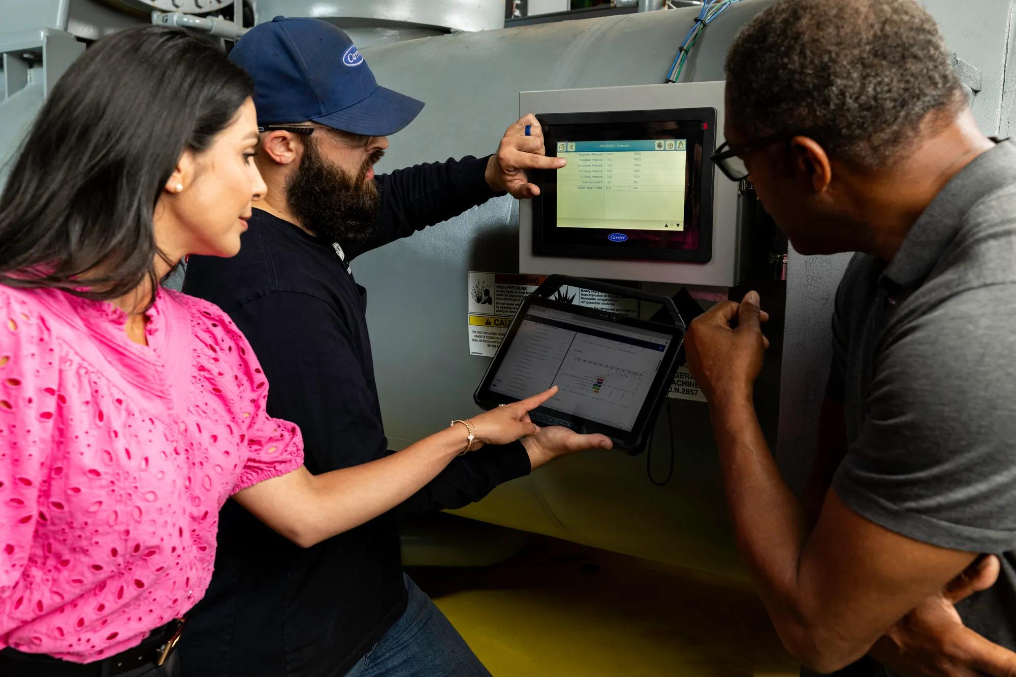 People inspecting an HVAC system
