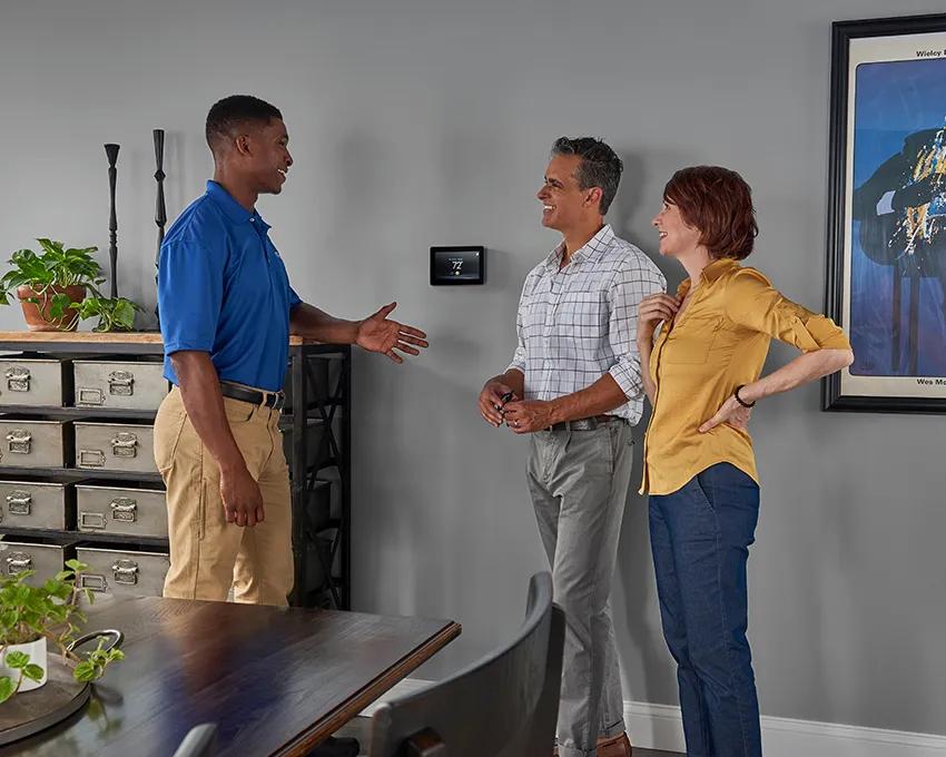 A Carrier Performance Series air conditioner installed outside a brick home