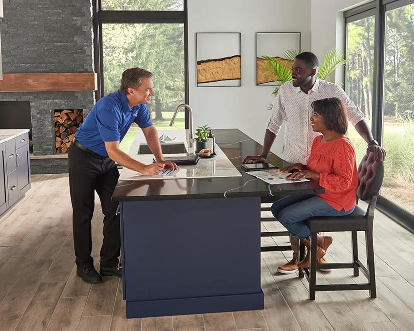 A dealer explaining the cost to install a geothermal HVAC system to homeowners