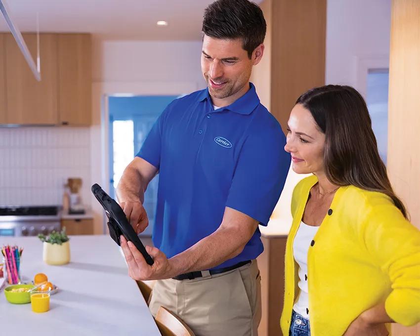 A Carrier dealer explaining energy efficiency to a homeowner