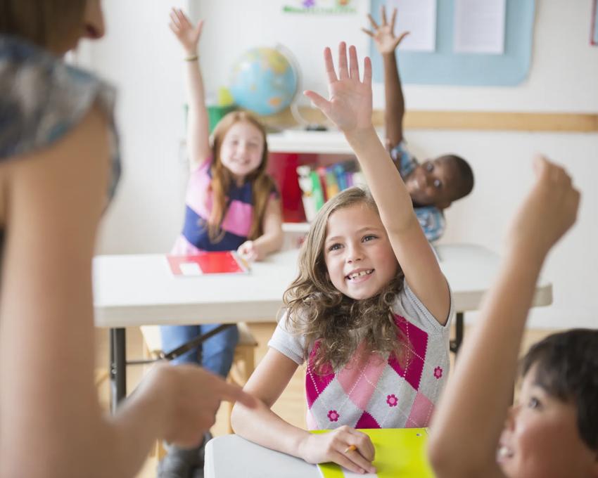 Teacher helping young children