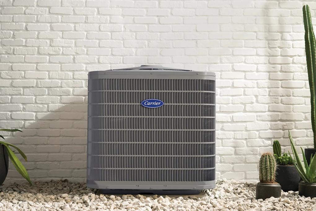 Heat pump outside a white desert home