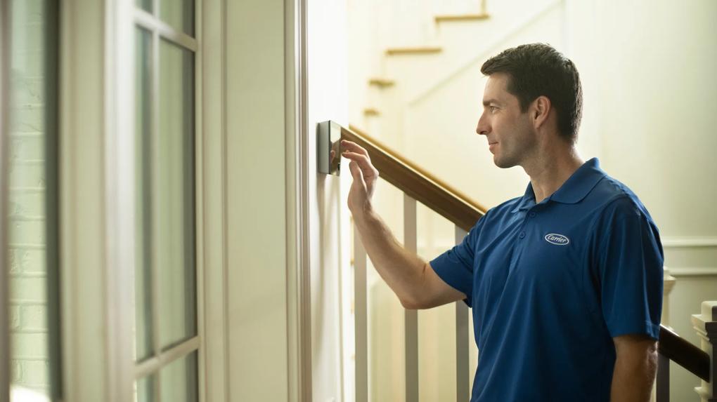 Carrier dealer installing new smart thermostat