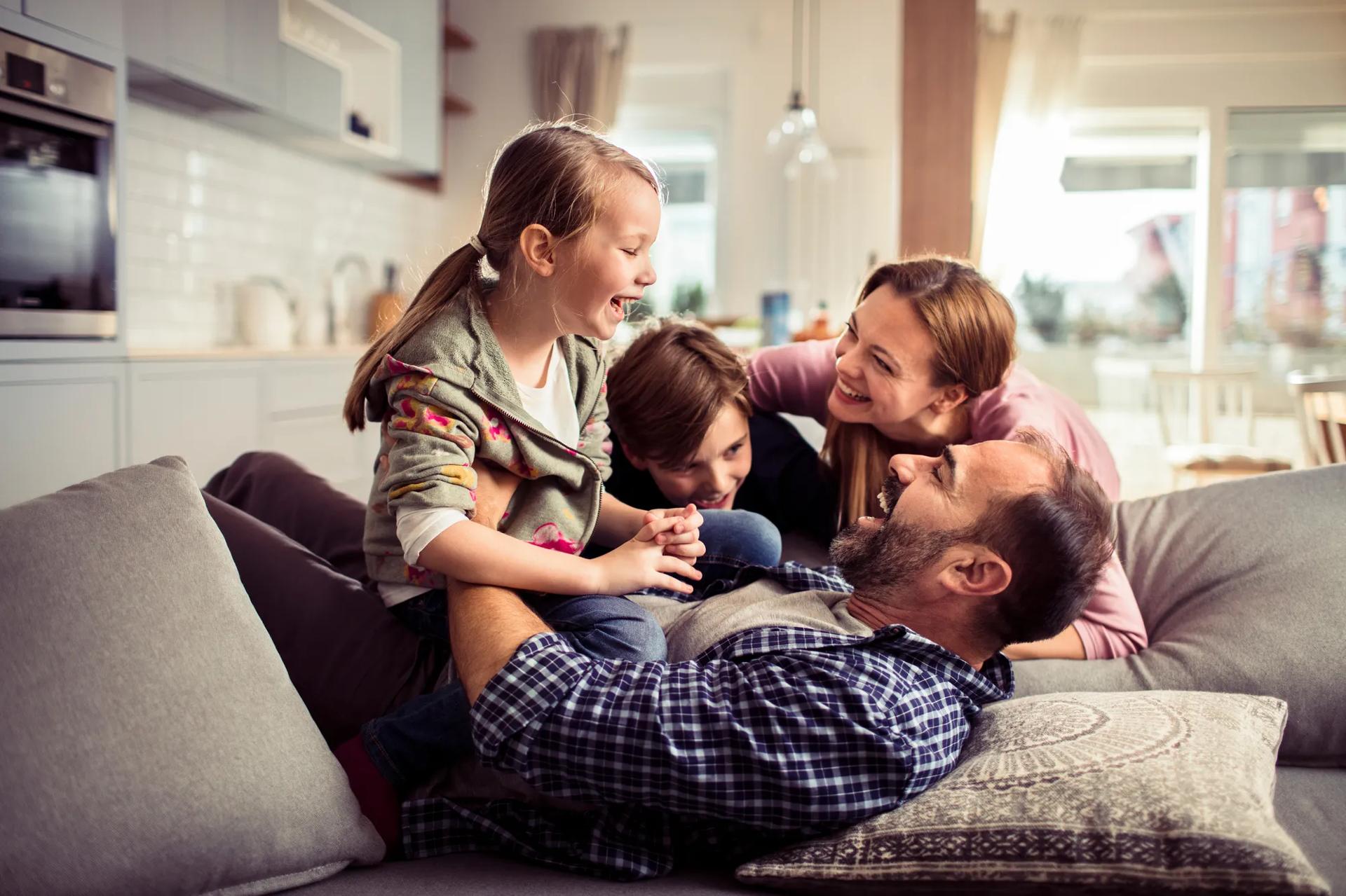 Happy family having fun on the couch at home